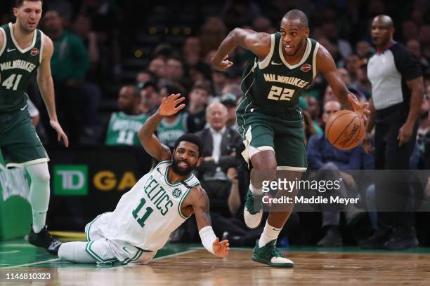 Kyrie Irving of the Boston Celtics dives after Khris Middleton of the Milwaukee Bucks during the second half of Game 3 of the Eastern Conference...