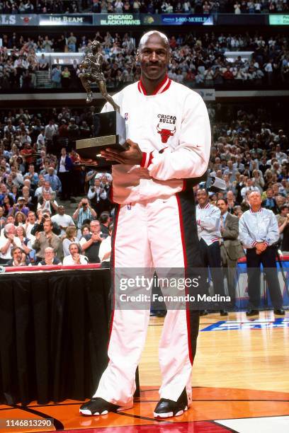 Michael Jordan of the Chicago Bulls poses for a photo with his 1998 MVP Trophy prior to a game against the Indiana Pacers Game Two of the Eastern...