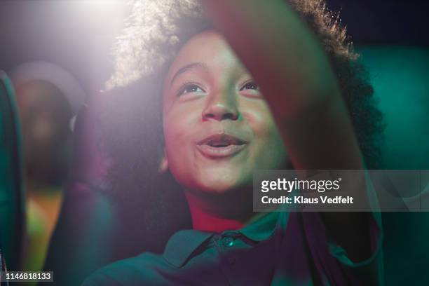 happy boy at movie theater - aufregung stock-fotos und bilder