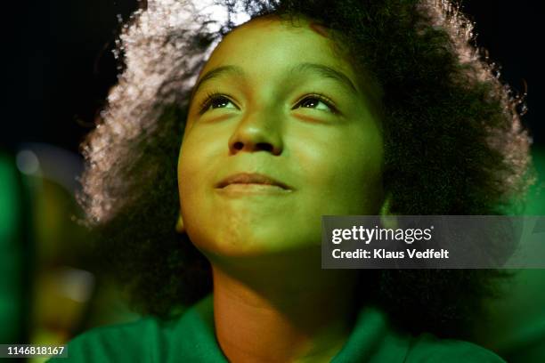 curious boy watching movie at theater - determination expression stock pictures, royalty-free photos & images