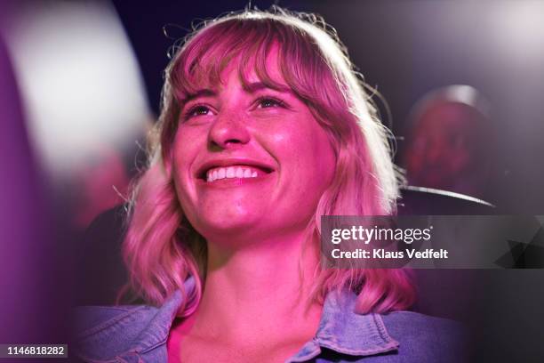 smiling woman at movie theater - kinositz stock-fotos und bilder