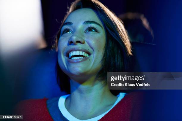 smiling woman enjoying at theater - arts culture and entertainment stock pictures, royalty-free photos & images