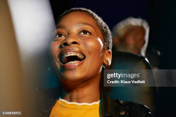 cheerful woman with braces at theater - dark humor stock pictures, royalty-free photos & images