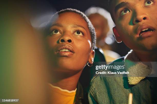 surprised friends watching thriller movie - facing fear stock pictures, royalty-free photos & images
