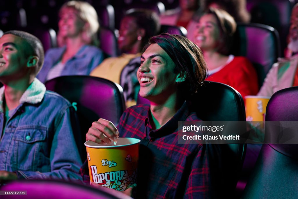 Happy audience watching movie in cinema hall