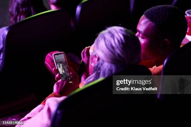 grandmother showing mobile phone to grandson - men women & children film stock-fotos und bilder