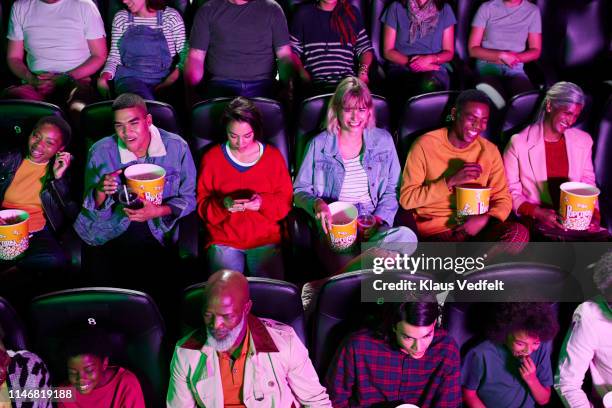 happy people enjoying movie at theater - popcorn full frame stock pictures, royalty-free photos & images