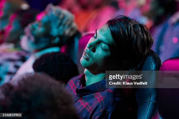 man sleeping in theater - man sleeping stock pictures, royalty-free photos & images