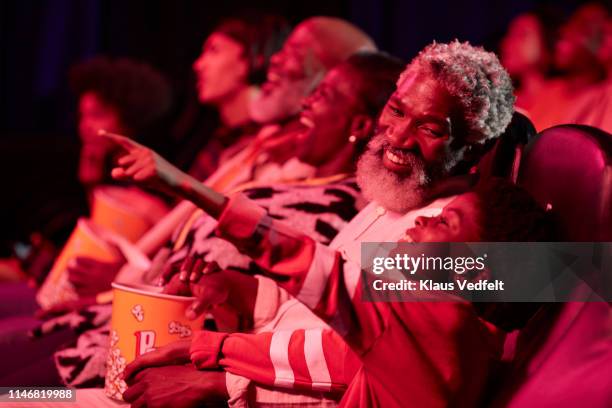 happy father with excited daughter in theater - black theatre stock pictures, royalty-free photos & images