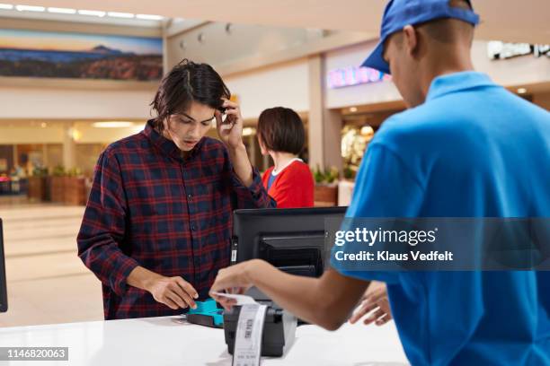 customer paying through credit card at theater - ticket counter fotografías e imágenes de stock