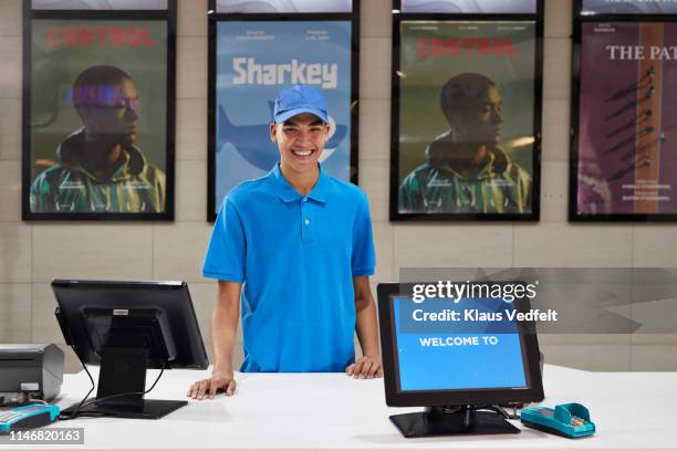 portrait of smiling cashier at theater - fahrkartenschalter stock-fotos und bilder