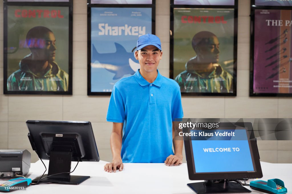 Portrait of male cashier at ticket counter