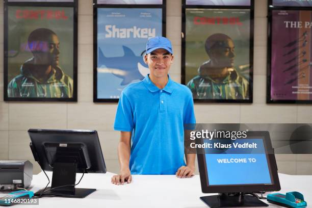 portrait of male cashier at ticket counter - cashier counter stock pictures, royalty-free photos & images