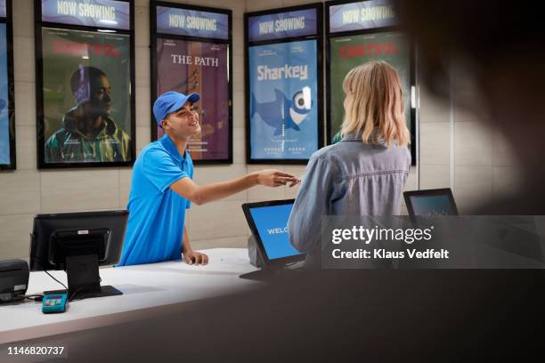 cashier giving movie tickets to customer - film poster stock pictures, royalty-free photos & images