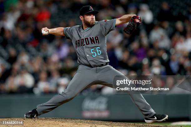 Pitcher Greg Holland of the Arizona Diamondbacks throws in the ninth inning against the Colorado Rockies at Coors Field on May 03, 2019 in Denver,...