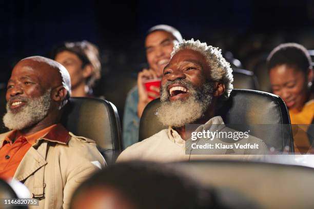 cheerful multi-ethnic spectators watching movie in cinema hall at theater - black theatre stock pictures, royalty-free photos & images