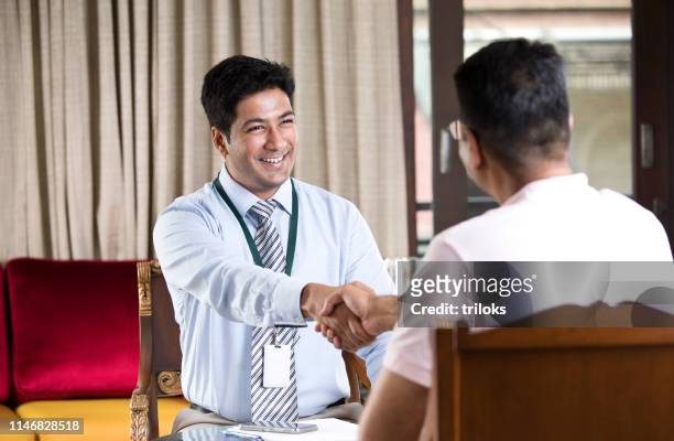 financial advisor shaking hands with customer - agreement stock pictures, royalty-free photos & images