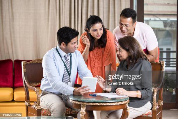 financial advisor with indian family - indian economy business and finance stock pictures, royalty-free photos & images