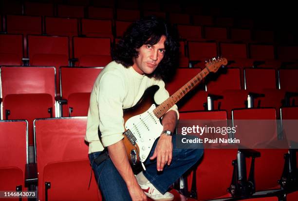 Portrait of American Rock musician Billy Squier as he poses, guitar in his arms, at the Rosemont Horizon, Rosemont, Illinois, November 7, 1981.
