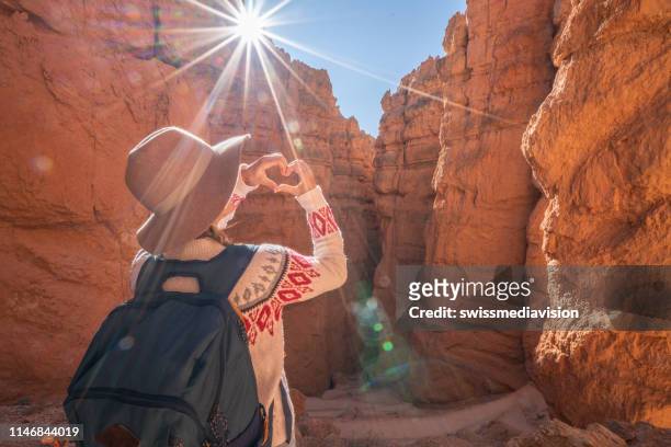 bryce canyon; le voyage de fille fait la forme de coeur avec des mains sur le paysage - bryce canyon photos et images de collection