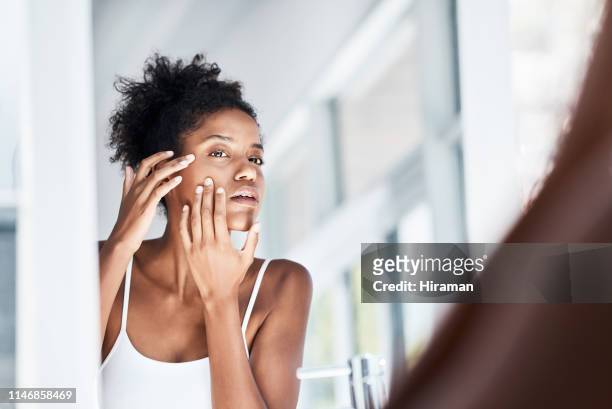 giving her skin the once over - touching skin stock pictures, royalty-free photos & images