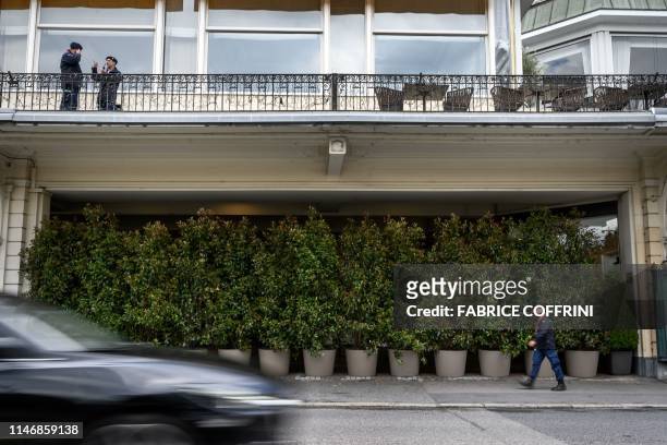 Private security guards stands at the entrance of The Fairmont Le Montreux Palace hotel hidden by plants in Montreux on May 29 which is scheduled to...