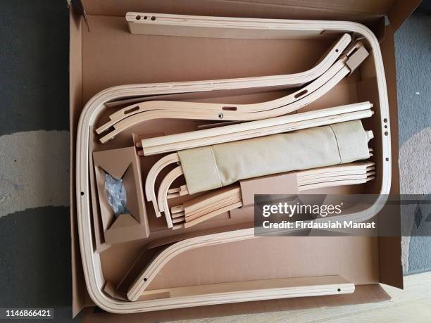 flat pack furniture in a cardboard box - ikea furniture stock pictures, royalty-free photos & images