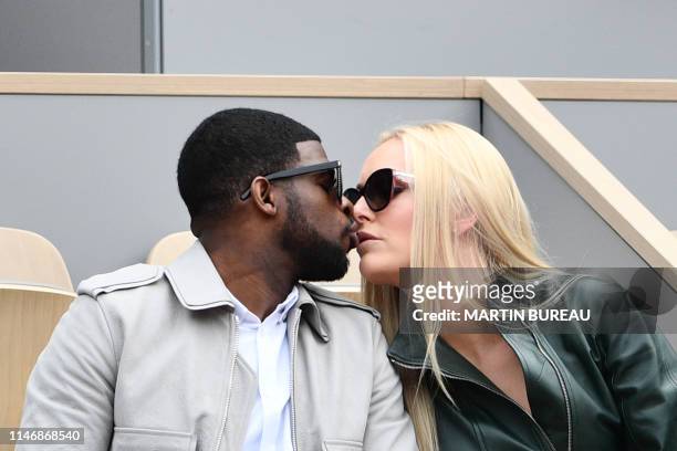 Former US skier Lindsey Vonn and partner US hockey player Pernell Karl Subban, kiss as they attend the men's singles second round match between...