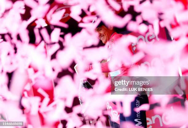 Team Movistar rider Ecuador's Richard Carapaz, with the pink jersey of overall leader celebrates during the podium ceremony after the stage seventeen...