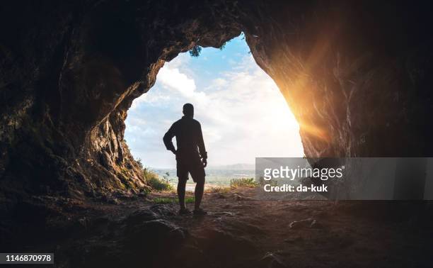 walking out of the cave - cave stock pictures, royalty-free photos & images