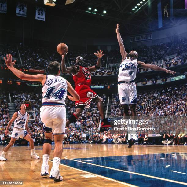 Michael Jordan of the Chicago Bulls passes the ball against the Utah Jazz during Game Two of the NBA Finals during the 1998 NBA Playoffs on June 5,...