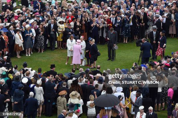 Britain's Queen Elizabeth II meets guests at the Queen's Garden Party in Buckingham Palace, central London on May 29, 2019.