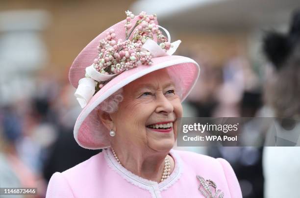 Queen Elizabeth II meets guests as she attends the Royal Garden Party at Buckingham Palace on May 29, 2019 in London, England.