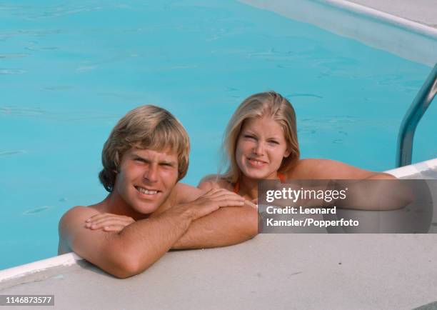 American golfer Ben Crenshaw with his wife Polly in a swimming pool, circa 1976.