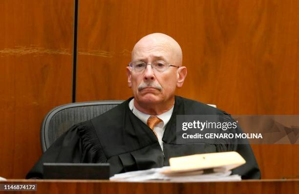 Superior Court judge Larry Paul Fidler watches as actor Ashton Kutcher testifies in court in Los Angeles on May 29 during the trial of People v...