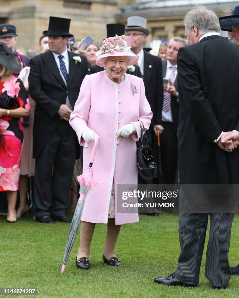 Britain's Queen Elizabeth II meets guests at the Queen's Garden Party in Buckingham Palace, central London on May 29, 2019.