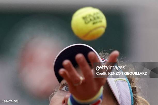 Germany's Laura Siegemund serves the ball to Switzerland's Belinda Bencic during their women's singles second round match on day four of The Roland...