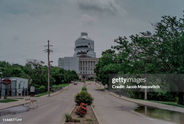 The Missouri State Capitol building sits wrapped in construction tarps as floodwater seeps onto W Main Street on May 29, 2019 in Jefferson City,...