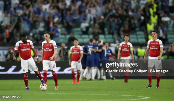 Arsenal players look dejected after Chelsea's Olivier Giroud scores his side's first goal of the game during the UEFA Europa League final at The...