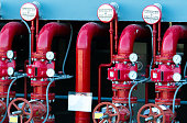 Main supply water piping in the fire extinguishing system. Fire sprinkler system with red pipes. Fire suppression. Manual valve of Fire extinguisher system.