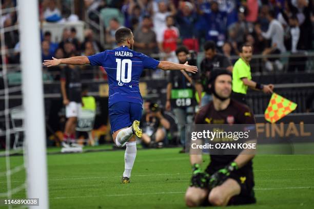 Chelsea's French striker Olivier Giroud celebrates after scoring a goal as Arsenal's Czech goalkeeper Petr Cech reacts during the UEFA Europa League...