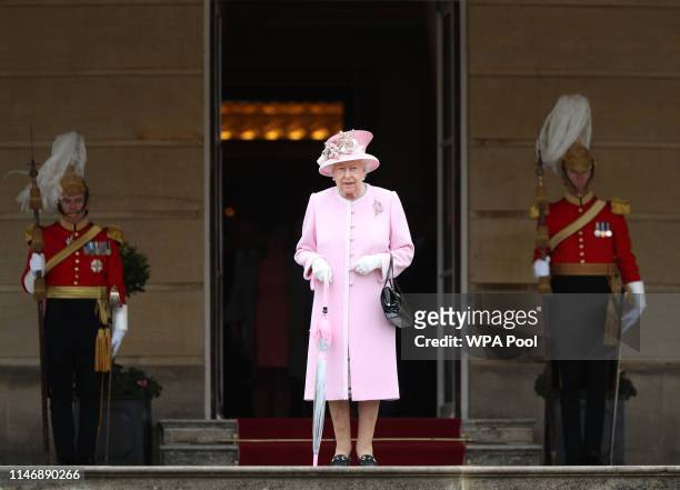 Queen Elizabeth II meets guests as she attends the Royal Garden Party at Buckingham Palace on May 29, 2019 in London, England.