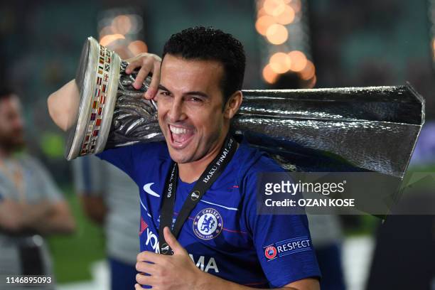 Chelsea's Spanish midfielder Pedro celebrates with the trophy after winning the UEFA Europa League final football match between Chelsea FC and...