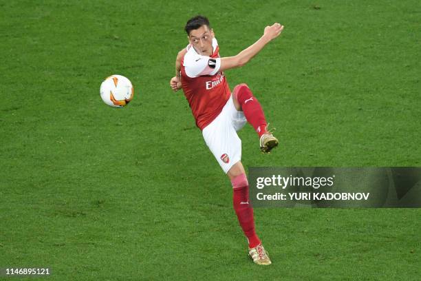 Arsenal's German midfielder Mesut Ozil plays the ball during the UEFA Europa League final football match between Chelsea FC and Arsenal FC at the...