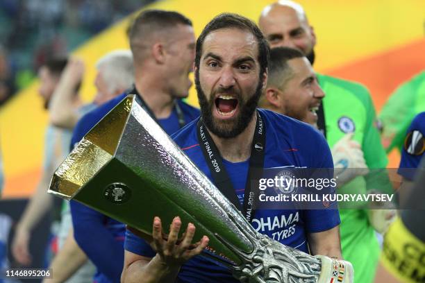 Chelsea's Argentinian striker Gonzalo Higuain celebrates with the trophy after winning the UEFA Europa League final football match between Chelsea FC...