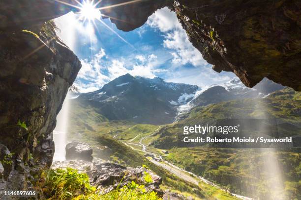 waterfall, susten pass, bern canton, switzerland - grotto cave stock pictures, royalty-free photos & images
