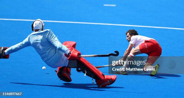 Sergi Enrique of Spain scores against George Pinner of Great Britain during a sudden death penalty shoot out during the Men's FIH Field Hockey Pro...