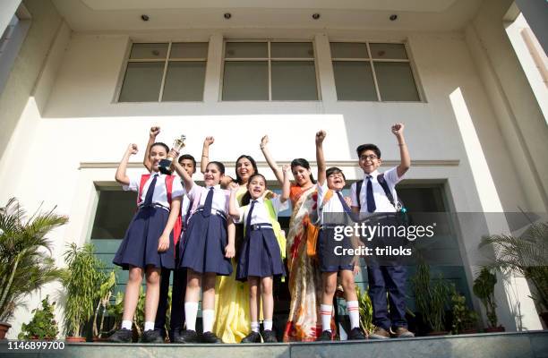 teachers with students celebrating success - title nine imagens e fotografias de stock