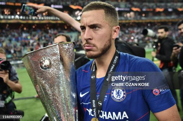 Chelsea's Belgian midfielder Eden Hazard holds the trophy after winning the UEFA Europa League final football match between Chelsea FC and Arsenal FC...