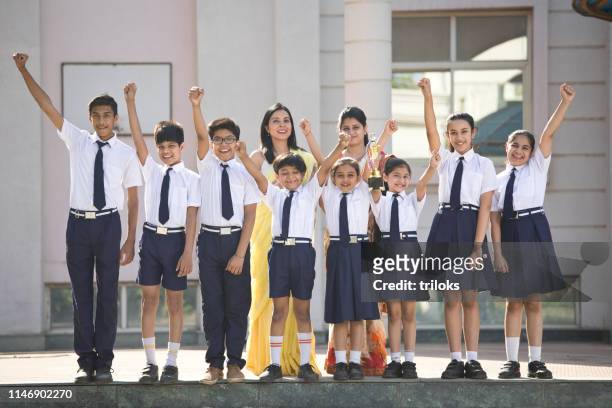 teachers with students celebrating success - organised group photo stock pictures, royalty-free photos & images